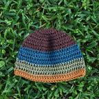 Colorful crocheted beanie on grass.