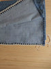 Video showing jeans being upcycled with crochet granny square inserts.