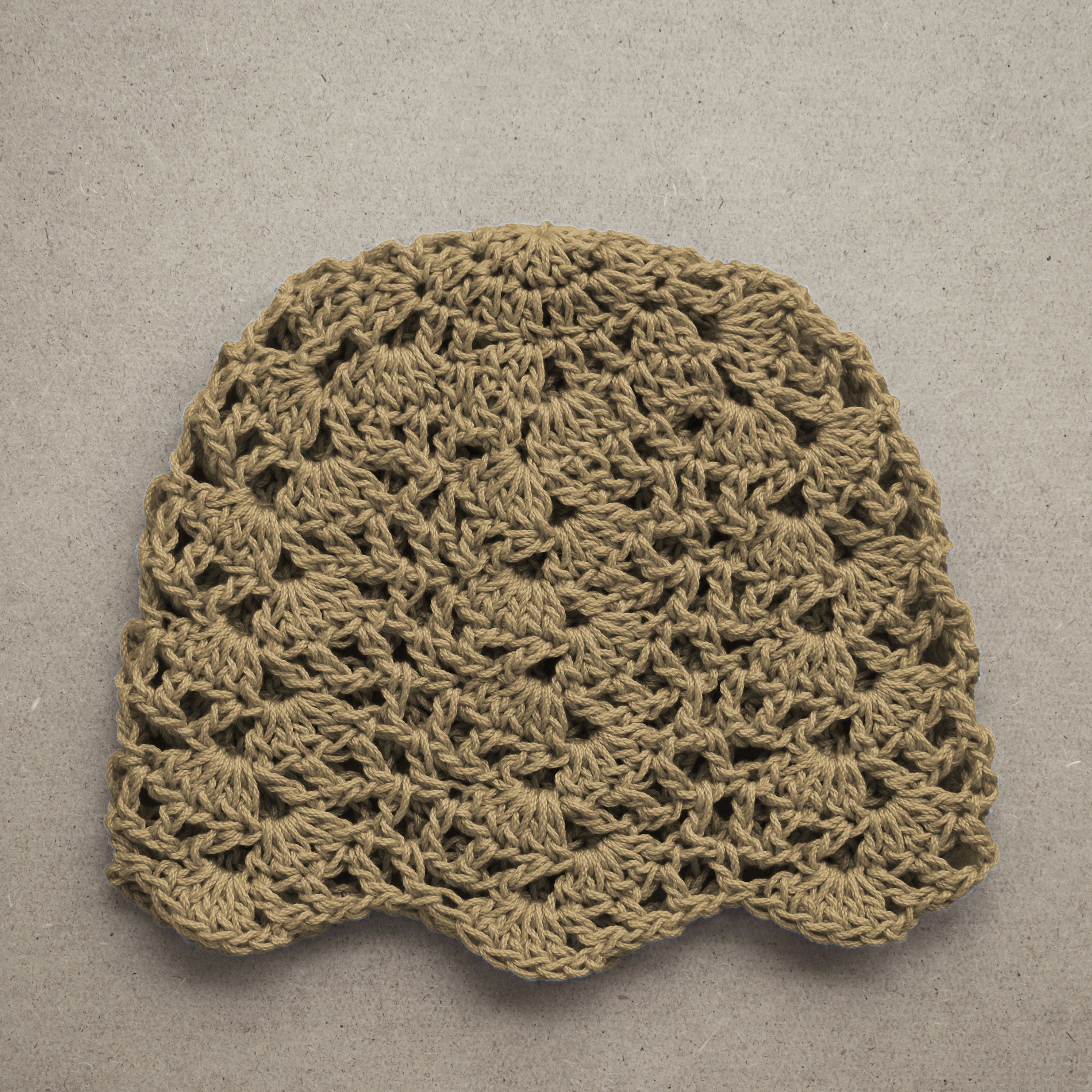 Crocheted tan hat on a textured beige background.