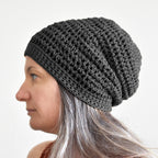 Woman wearing a gray knit beanie against a white background.